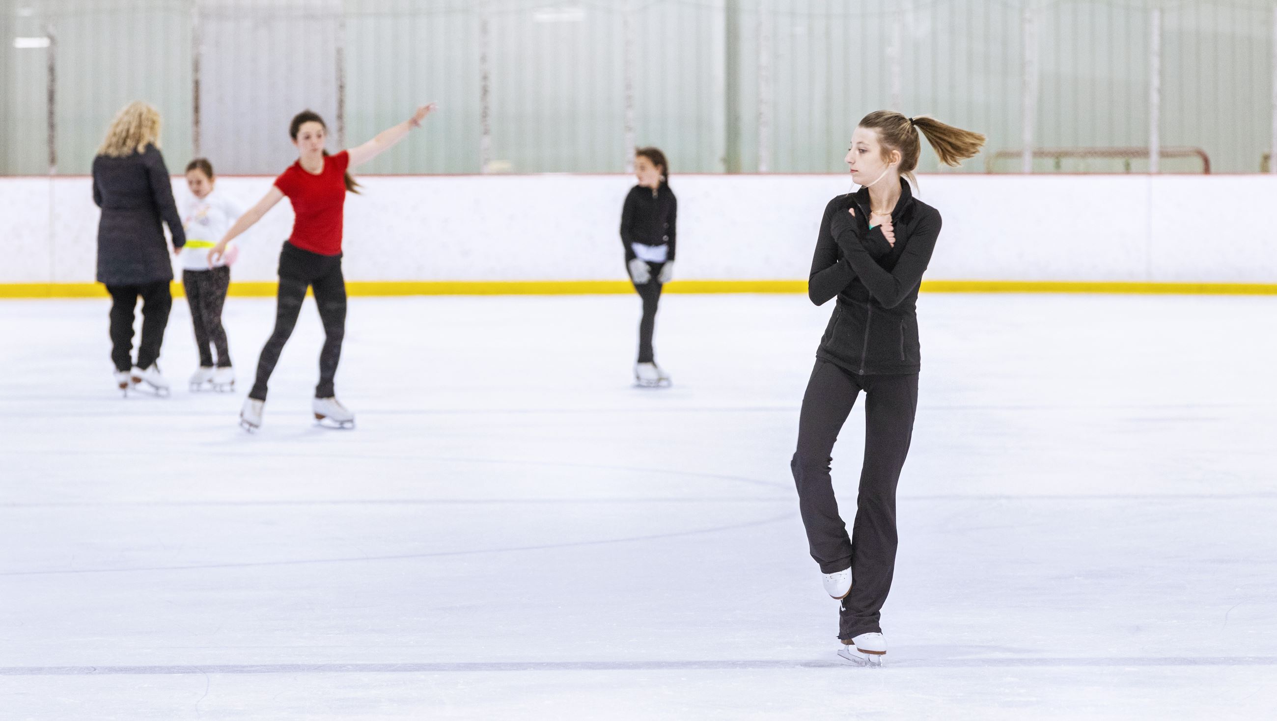 Young girl figure skating on ice