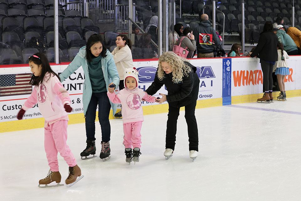 Skate coach helping your girl skater on ice rink